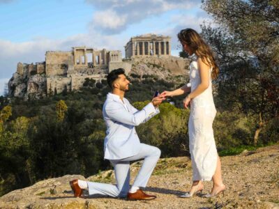 Athens proposal, man proposing to woman with Acropolis and Parthenon temple visible at the background